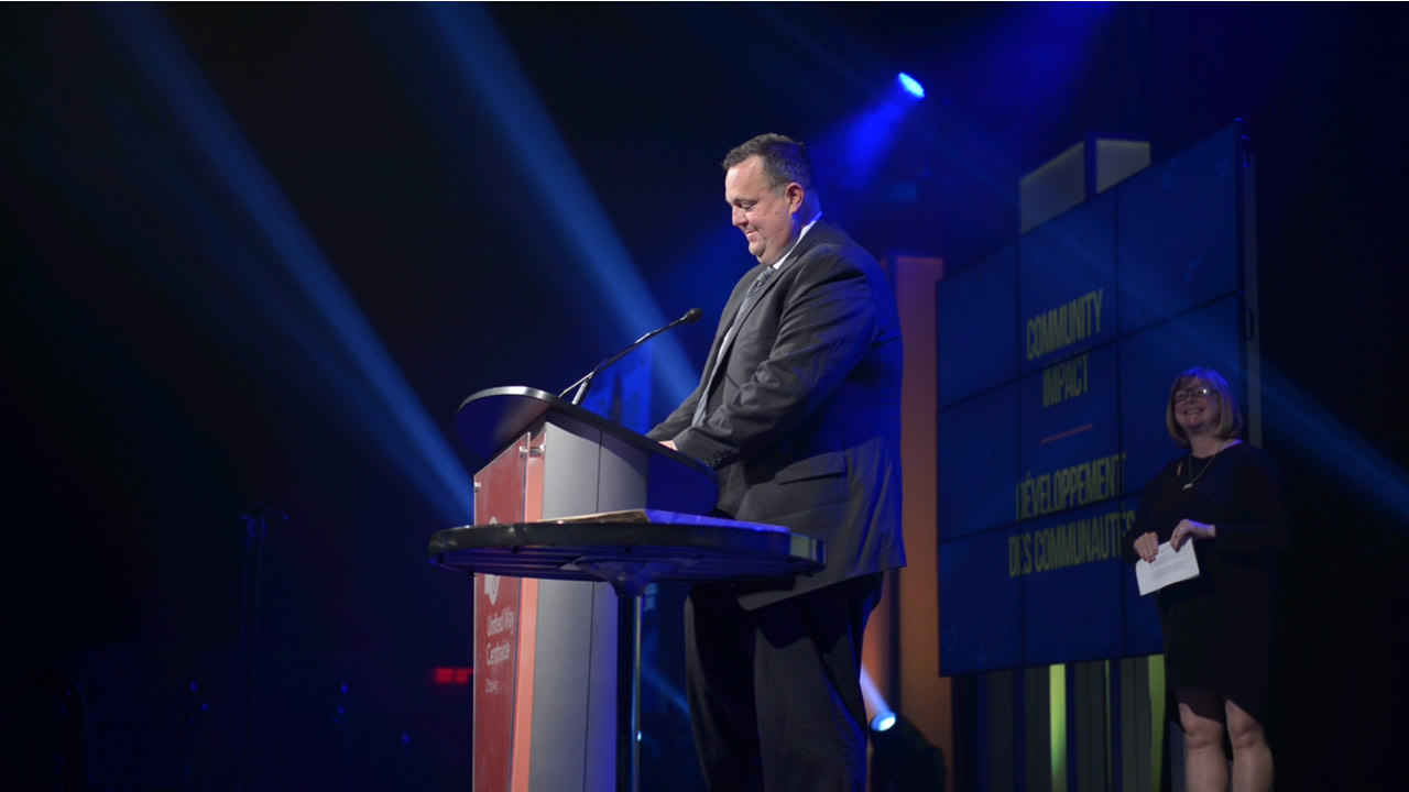 Bryce Conrad from Hydro Ottawa on stage giving at speech at the Community Builder Awards Gala.