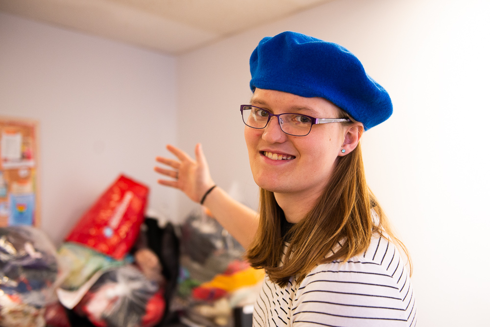 Penelope with a collection of clothes that will be featured at the next Affirm Project clothing swap.
